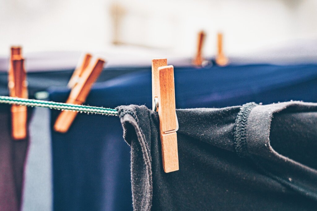 properly spaced clothes on drying rack near window with ventilation