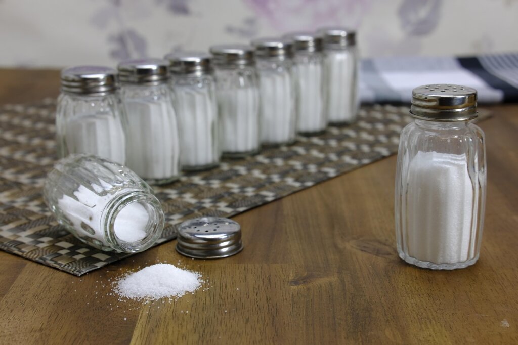 various DIY dehumidifier materials including salt charcoal and calcium chloride on white background