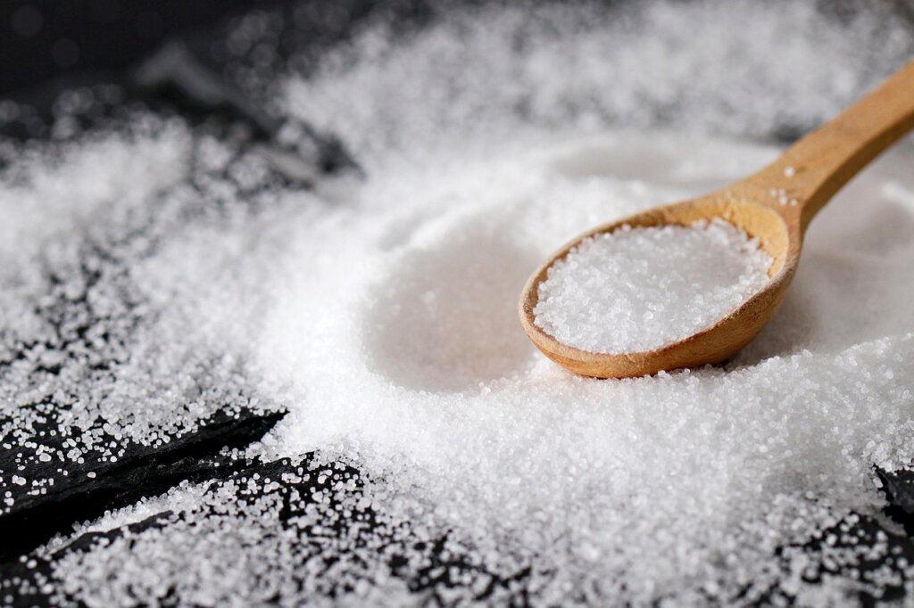 baking soda and white vinegar on kitchen counter with spoon