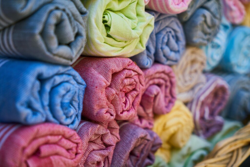 wet clothes rolled in dry towel to remove water