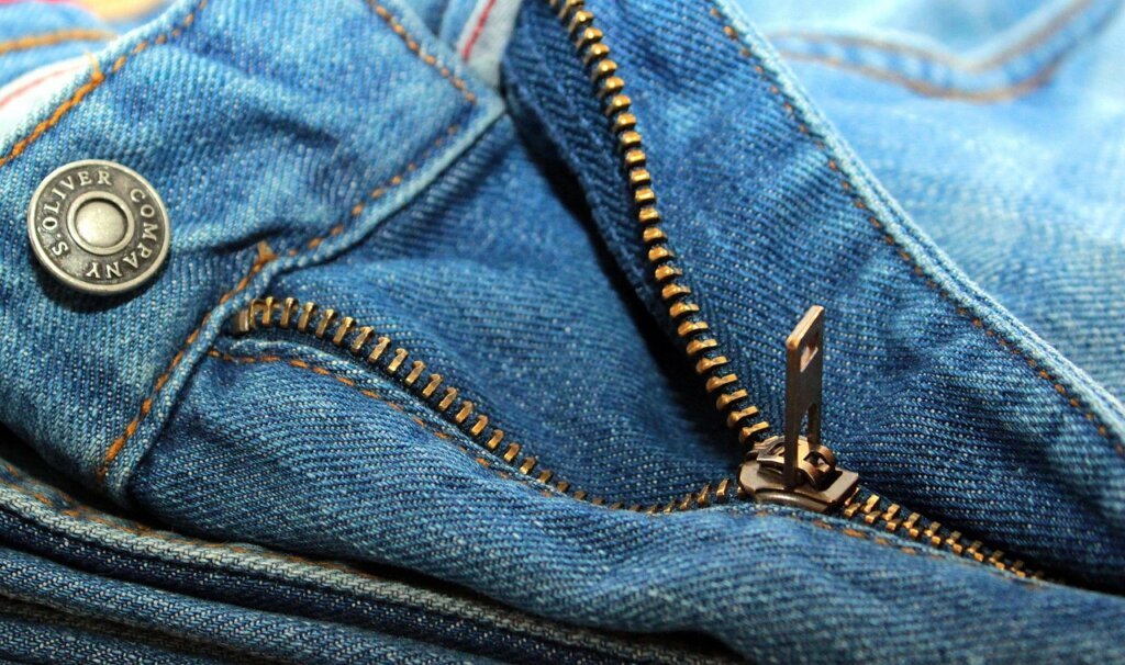 person checking storage bag zipper seam carefully