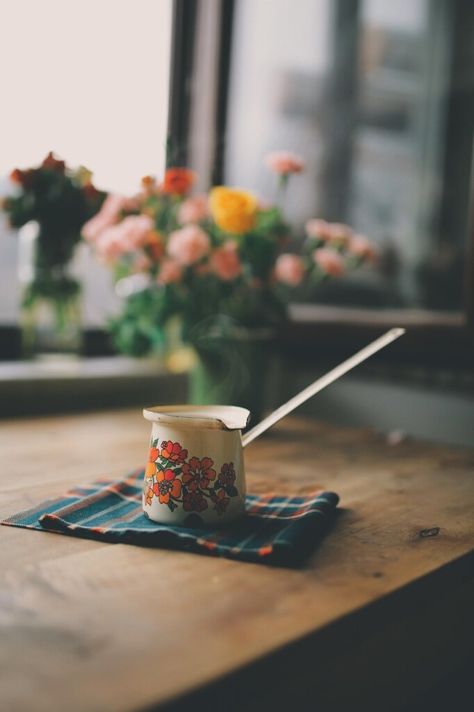 digital kitchen scale next to paper cup and spoon