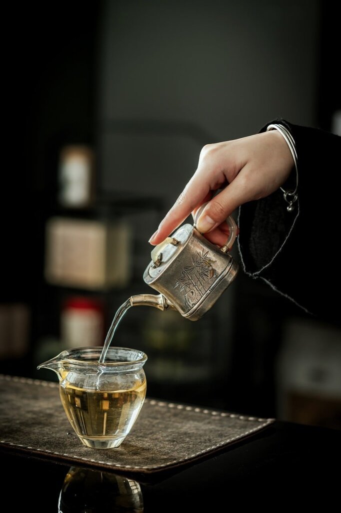 woman pouring warm water into tumbler with citric acid