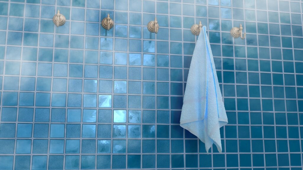 waterproof sealant being applied to bathroom tile grout with small brush