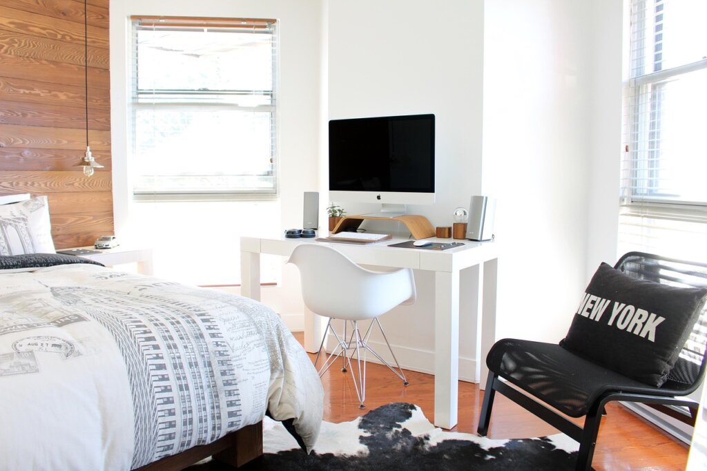 bedroom with open window and sunlight, dehumidifier and clean bedding