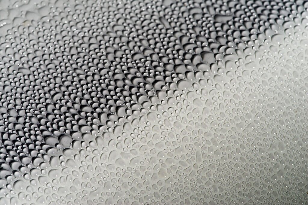 applying hydrophobic coating spray on clean glass window