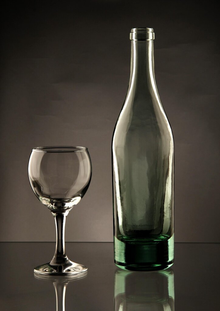 white vinegar and citric acid spray bottle next to glass window