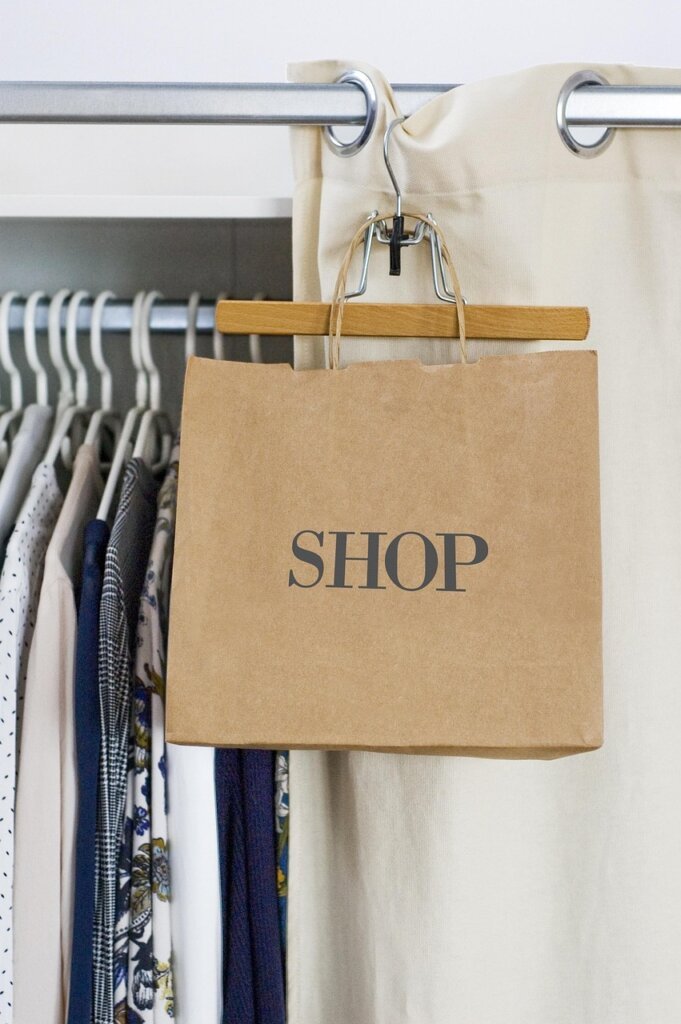 charcoal dehumidifier bag placed inside wardrobe with clothes