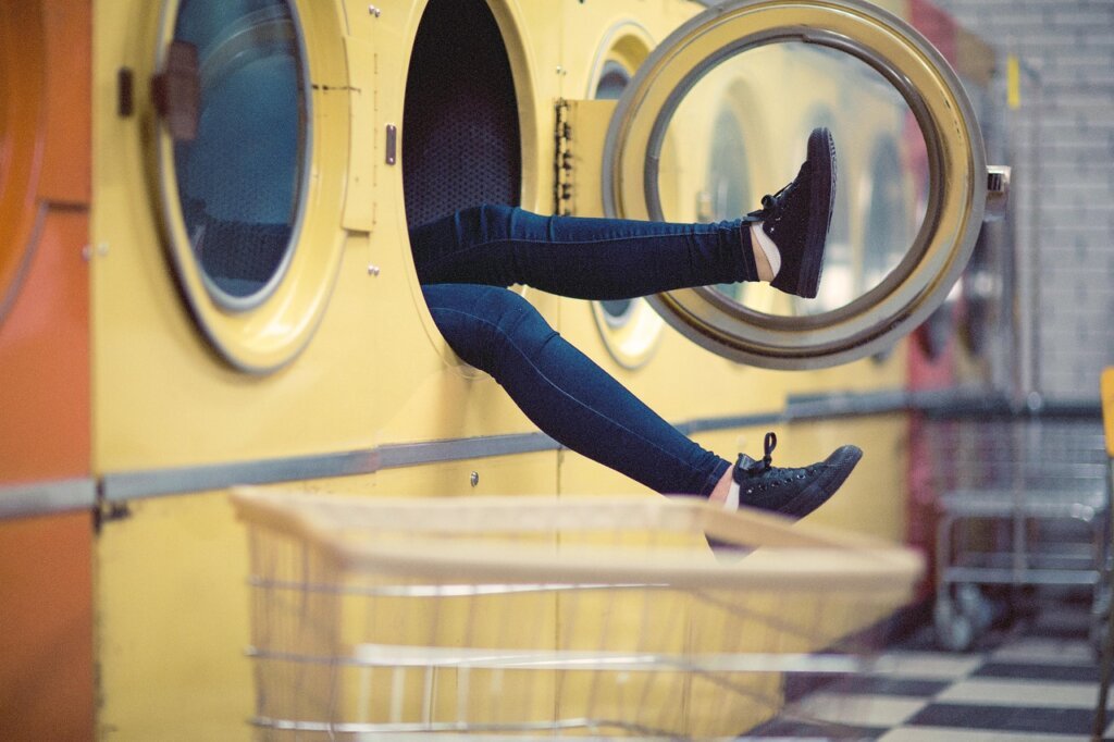 open washing machine door drying naturally in bright laundry room
