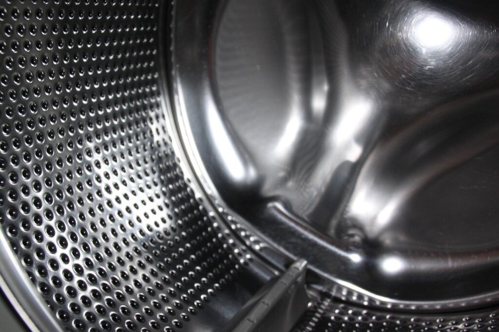 close-up of drum washing machine interior with mold residue