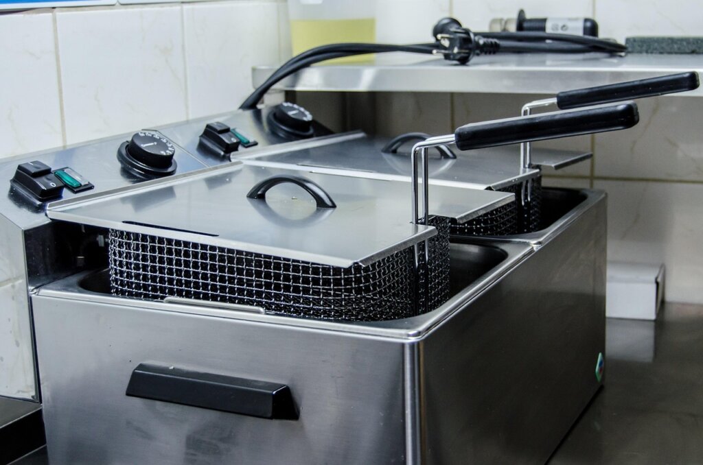 kitchen paper towel wiping warm air fryer basket after cooking