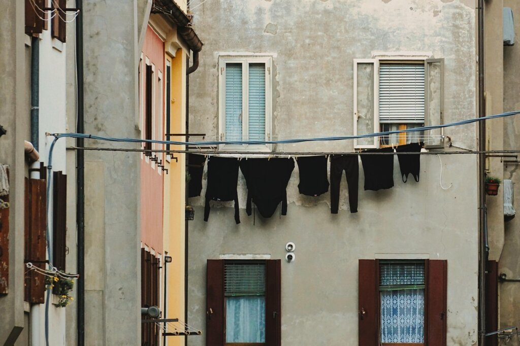 tidy laundry utility room with open window and dehumidifier