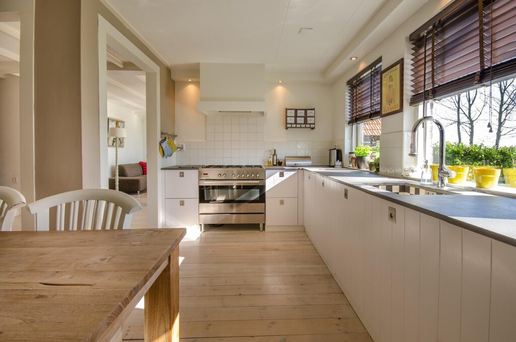 baking soda and white vinegar on kitchen counter next to sink