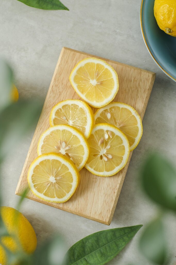 lemon halves and citrus peels near kitchen sink disposer