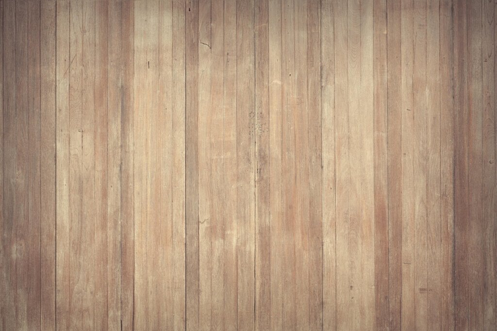 floor wax stripper being applied on wooden floor with mop