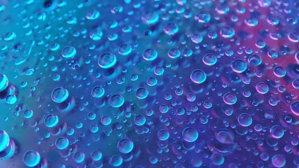 fabric protector spray being applied to light-colored sofa surface