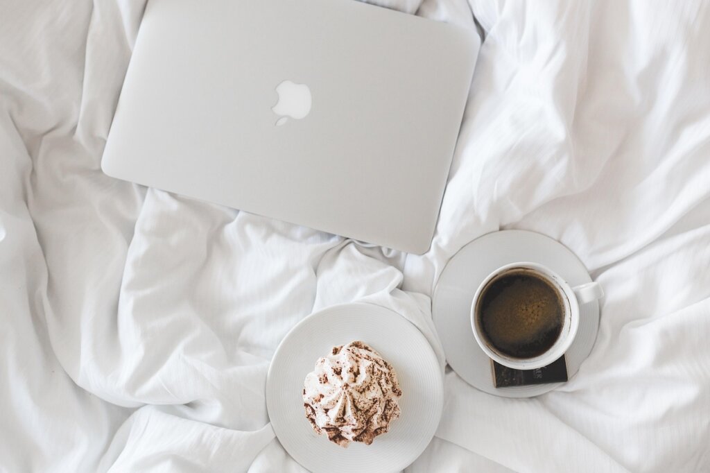 clean bed with freshly made white sheets